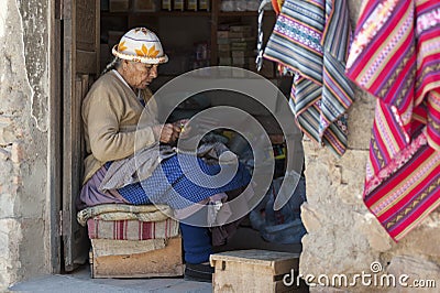 Unidentified indigenous native Quechua woman with traditional tribal clothing and hat, at the Tarabuco Sunday Market, Bolivia Editorial Stock Photo